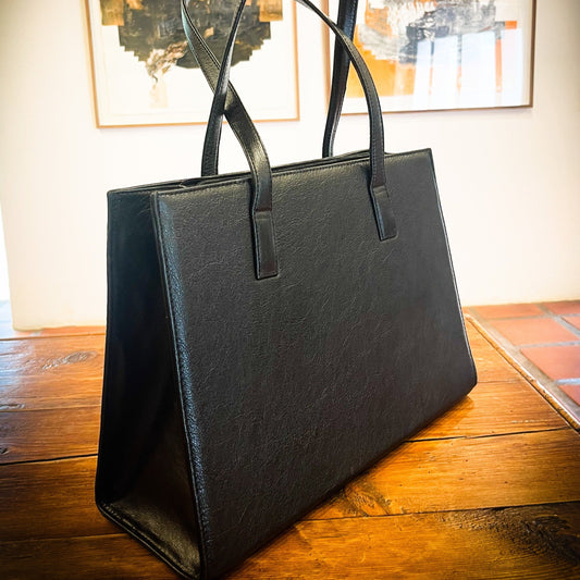 genuine leather tote or laptop bag on a wooden table