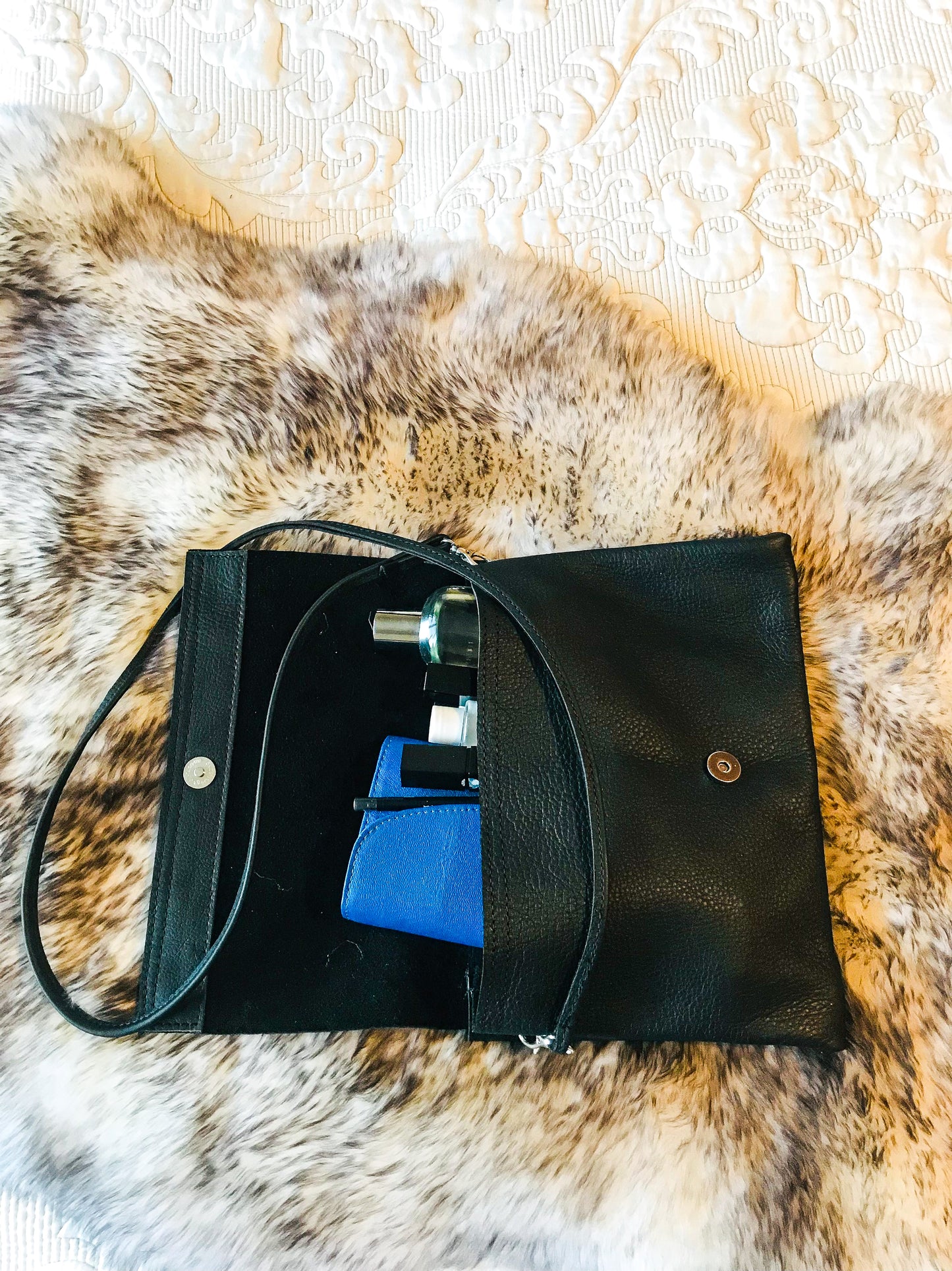 genuine leather black sling bag on sheepskin showing the inside of the bag 