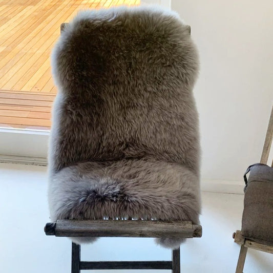 Genuine dyed grey sheepskin on a chair