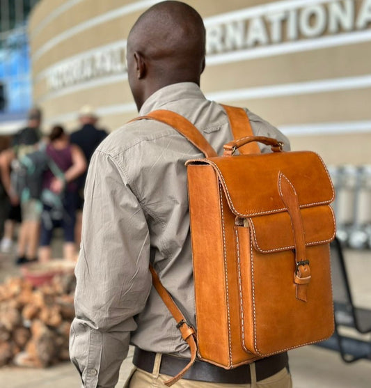 a man carrying a genuine leather handstitched backpack