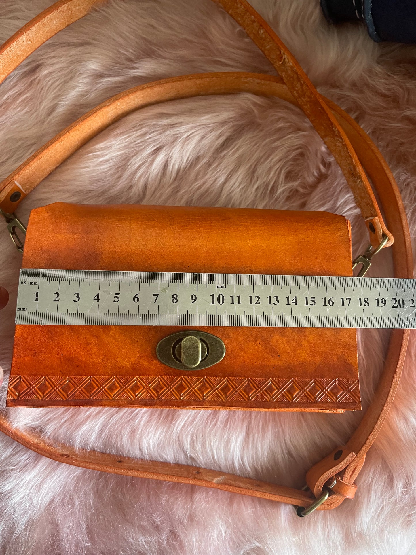 a measurement on a genuine leather orange bag