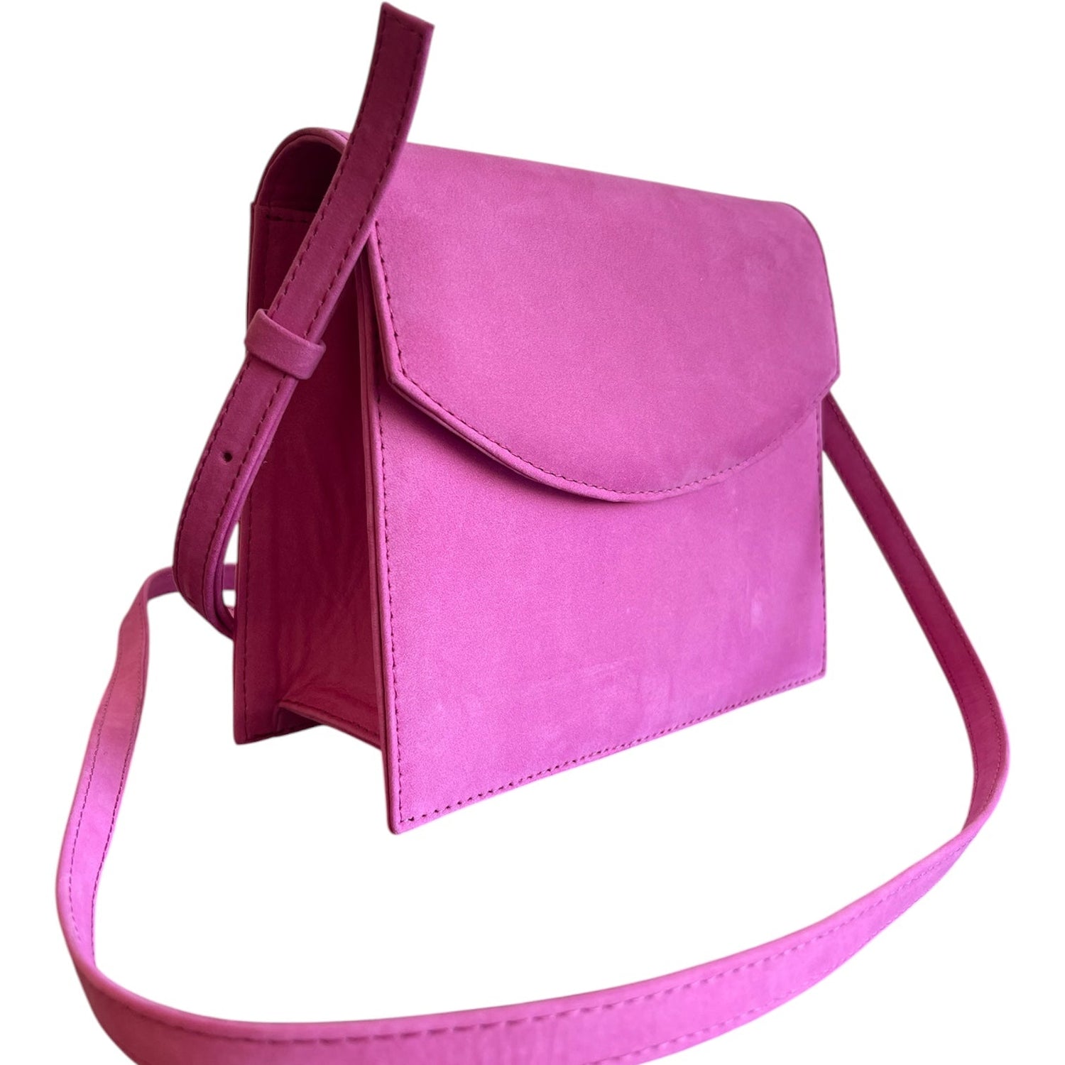 Pink handbag with a strap on a white background