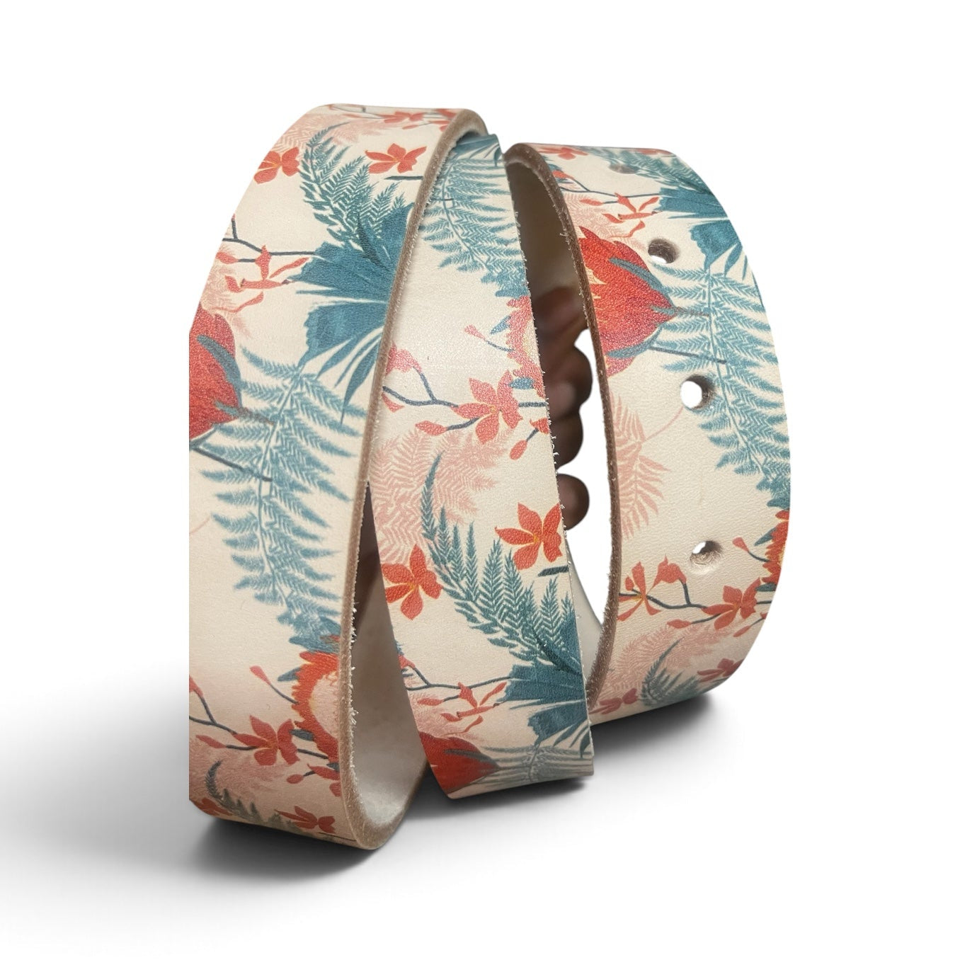A pair of adjustable silicone wristbands with a tropical floral and leaf pattern in teal, coral, and red on a cream background, displayed on a clean white background.