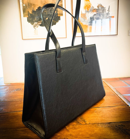 genuine leather tote or laptop bag on a wooden table