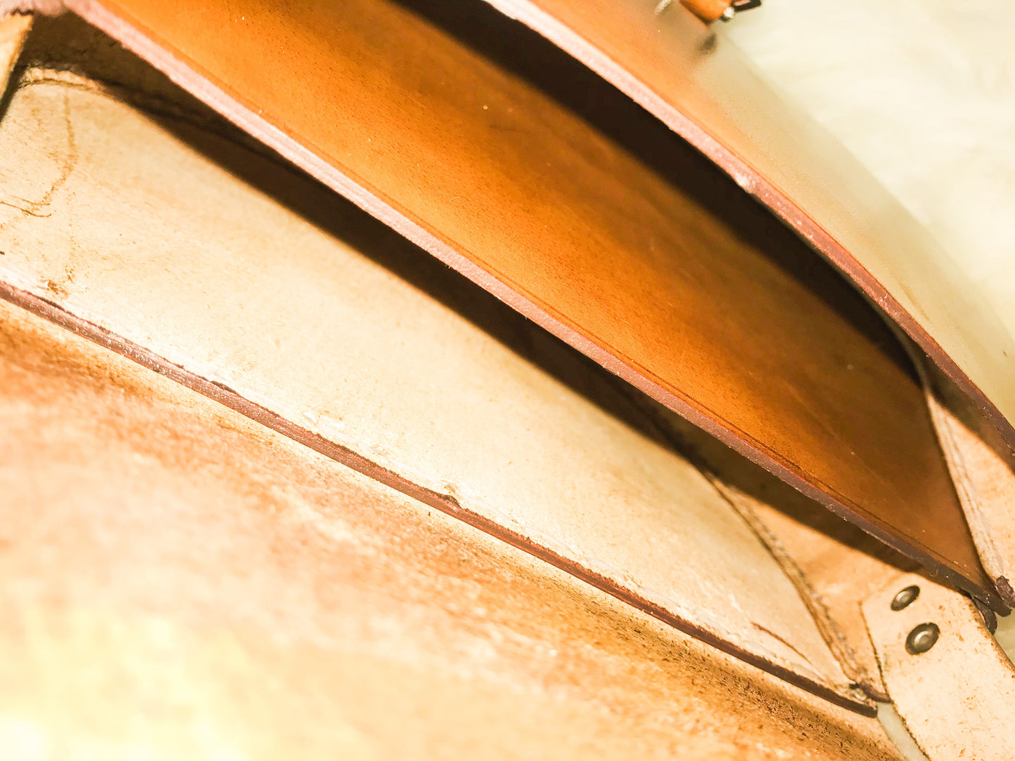 close up inside of genuine leather tan bag