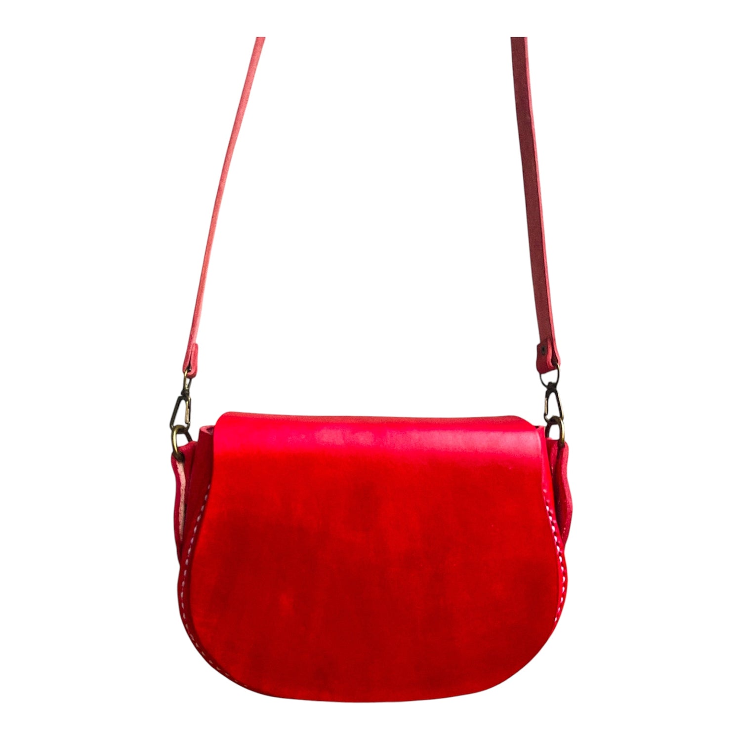 Red genuine leather handbag with a strap on a white background
