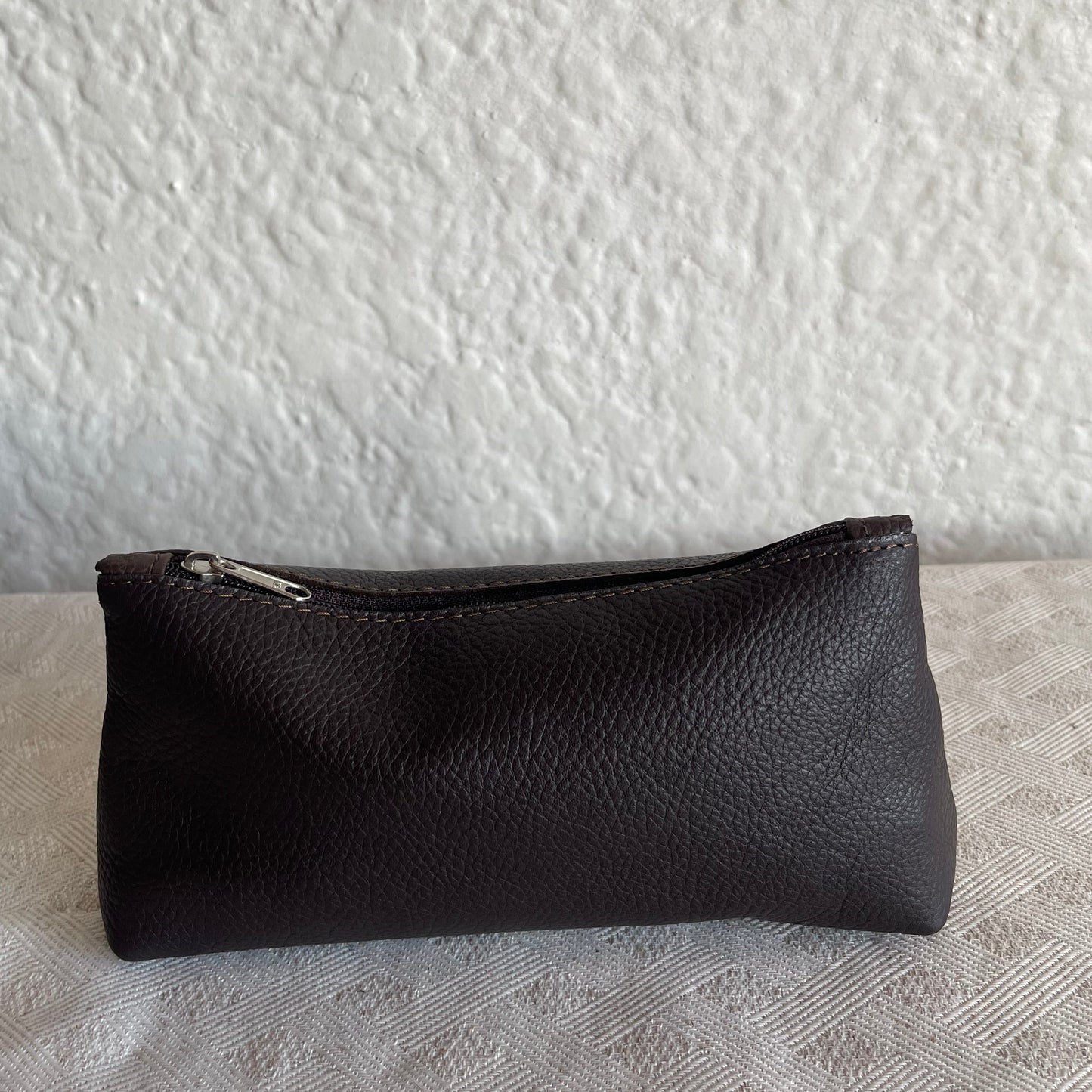 Black leather case on a textured white surface