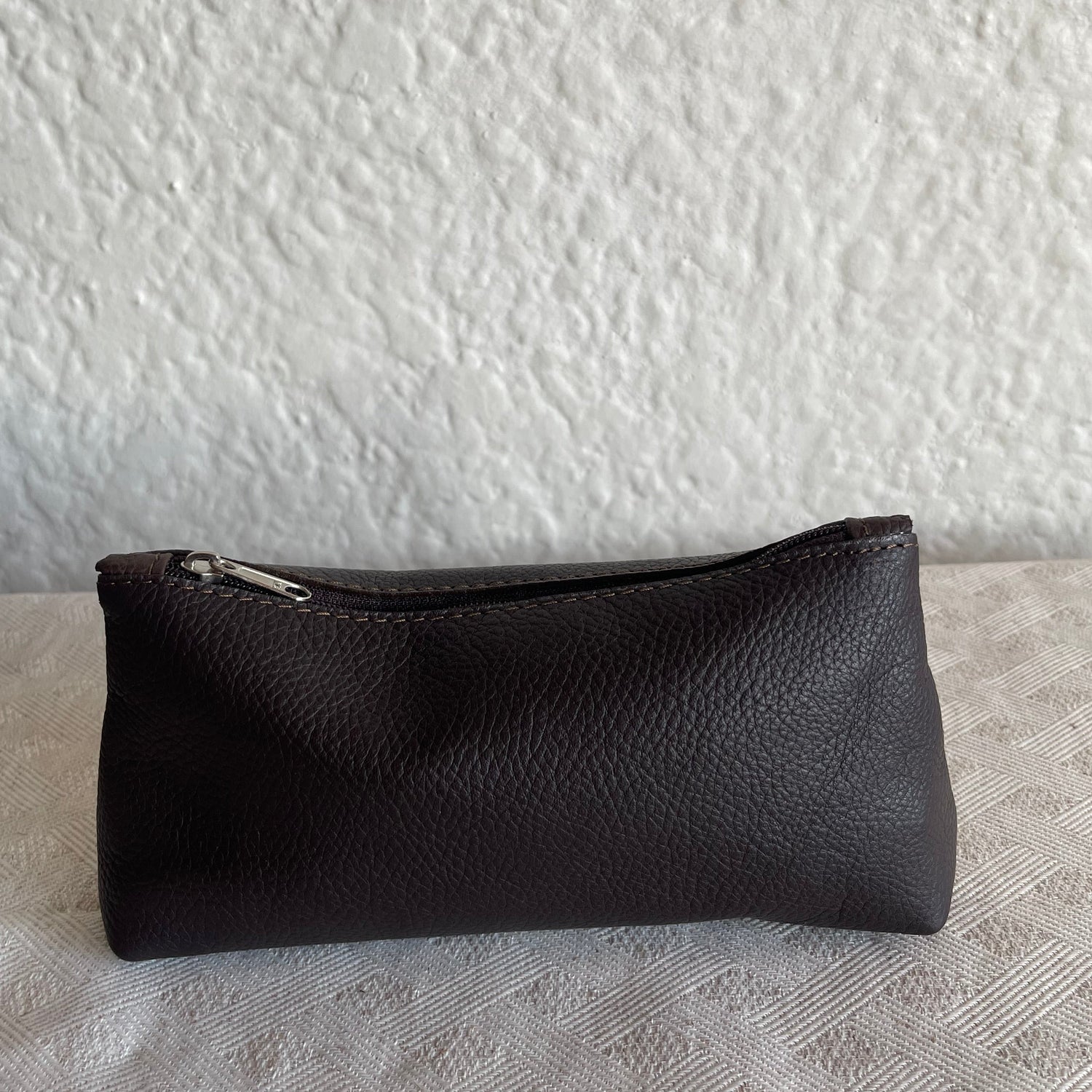 Black leather case on a textured white surface