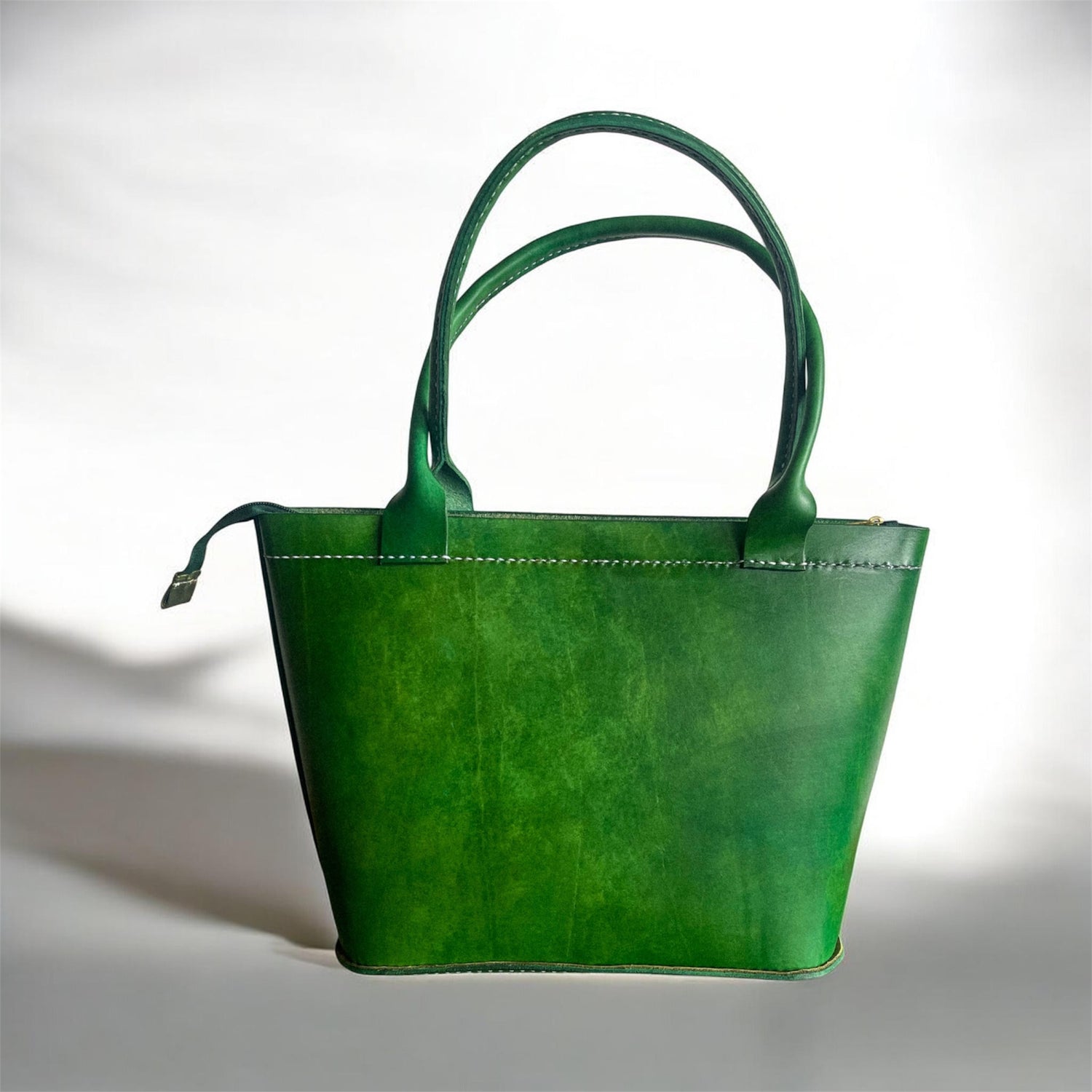 Green handbag on a light gray background