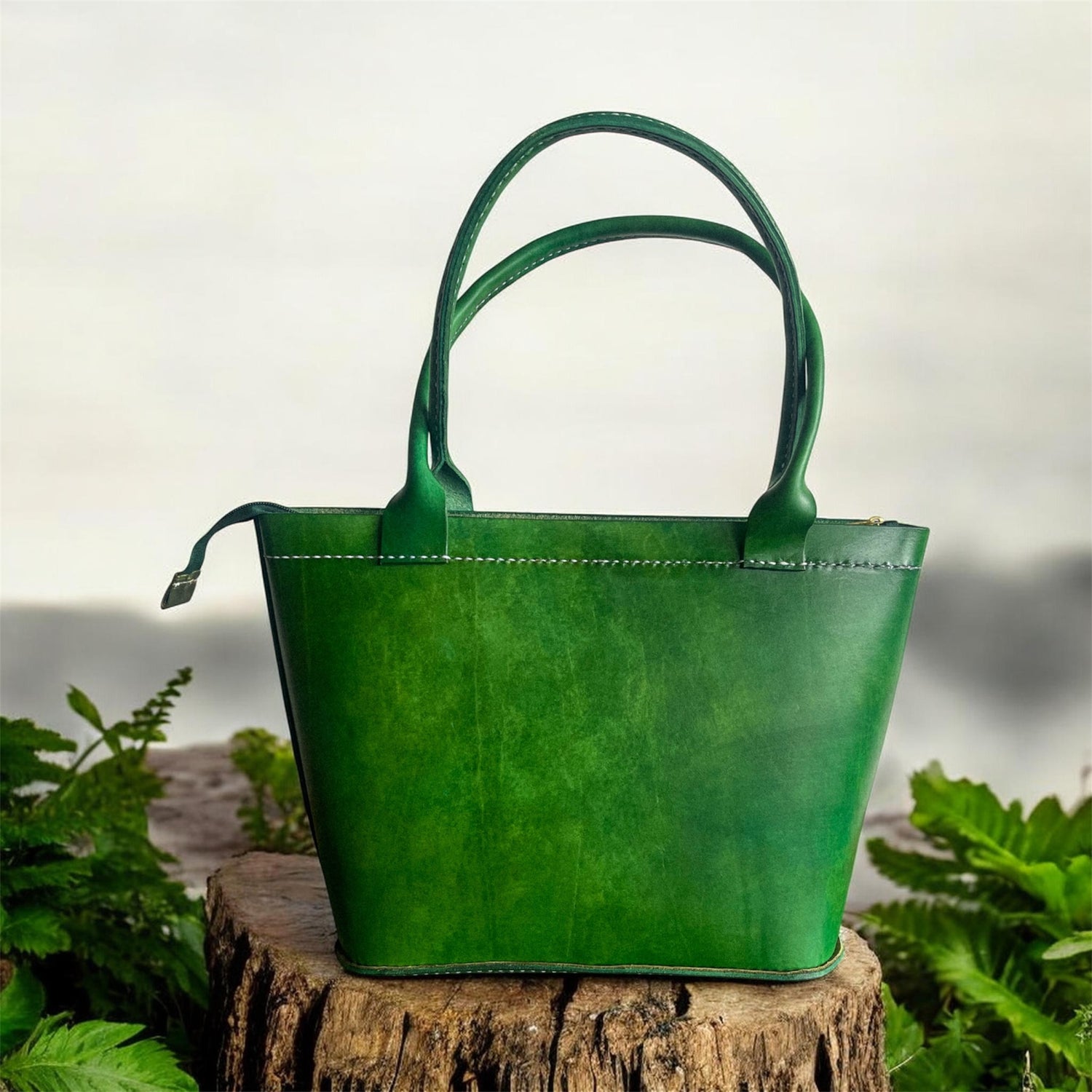Green handbag on a wooden stump with a natural background