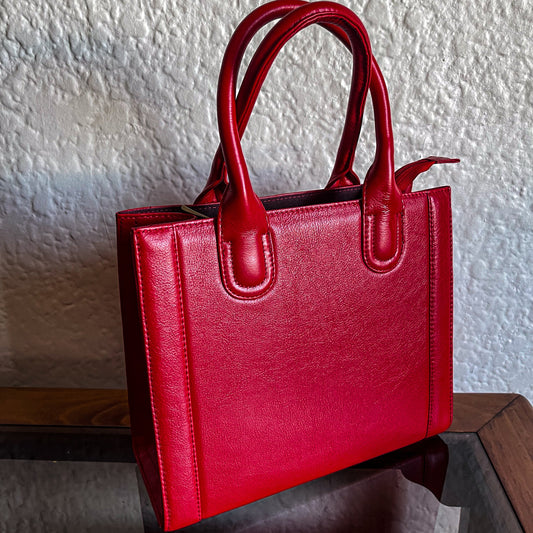 genuine leather small red handbag on a table