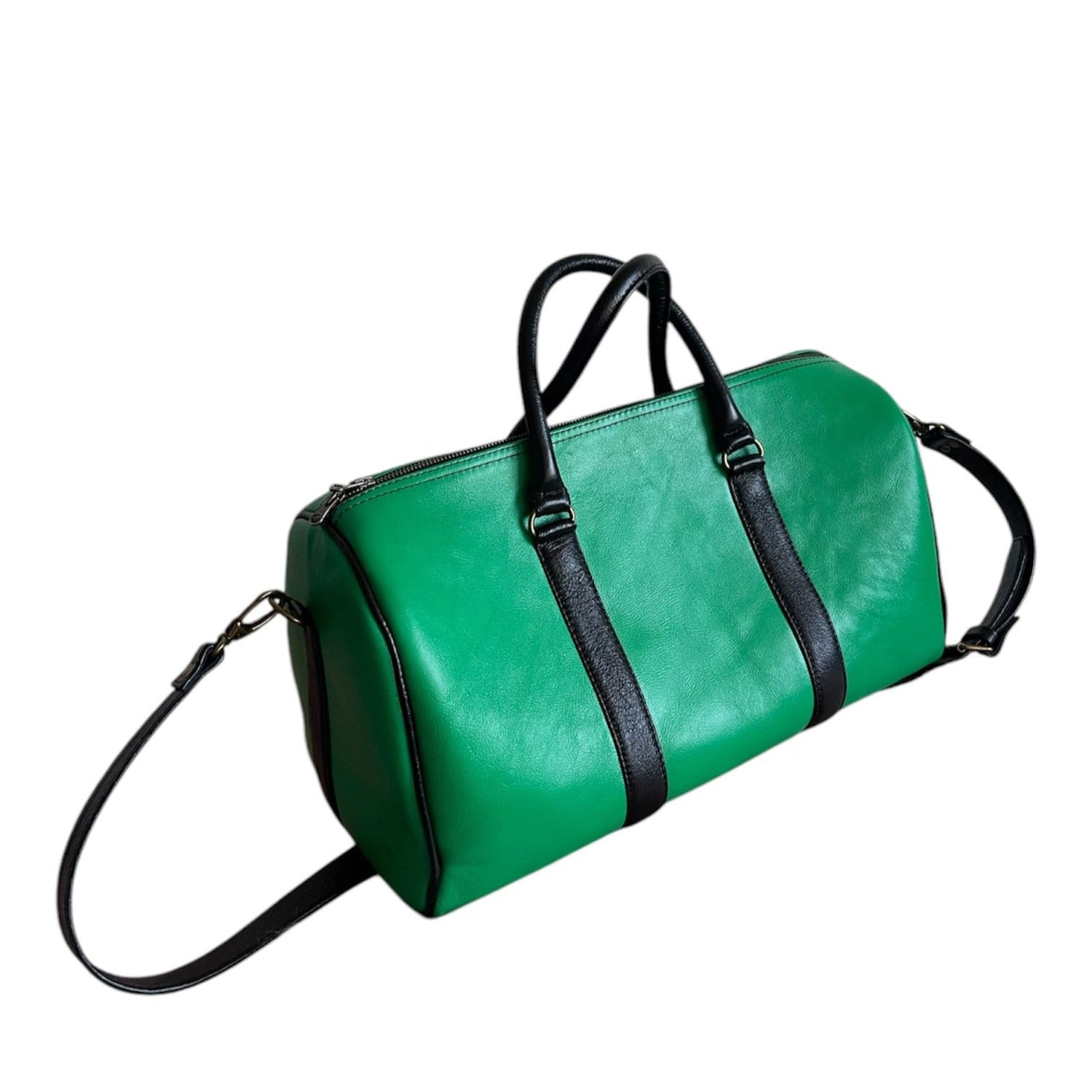 Green and black genuine leather weekender on white background
