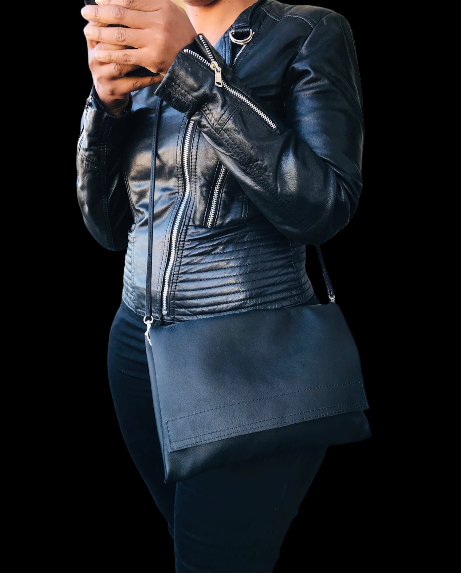a woman wearing a black genuine leather sling bag