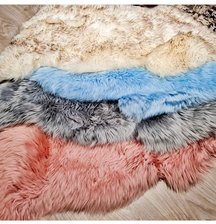 pile of pink, grey and blue sheepskins